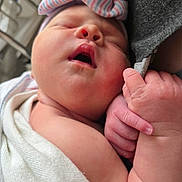 Remington joined the competition — help win amazing prizes! baby, blanket, bow, child, closeup, cute, finger, hand, headband, human, indoors, infant, newborn, peaceful, portrait, skin, sleeping, soft, tender, wrapped