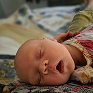 Remington joined the competition — help win amazing prizes! baby, sleeping, face, infant, mouth_open, floral_clothing, blanket, pillow, cozy, peaceful, closeup, portrait, child, rest, indoors, soft_lighting, cute, newborn, relaxation, bed