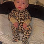 Xiomara joined the competition — help win amazing prizes! baby, bed, blanket, child, clothing, cushion, cute, expression, face, hair_clip, indoor, infant, leopard_print, onesie, person, portrait, puma_bag, red_eye, sitting, soft_lighting