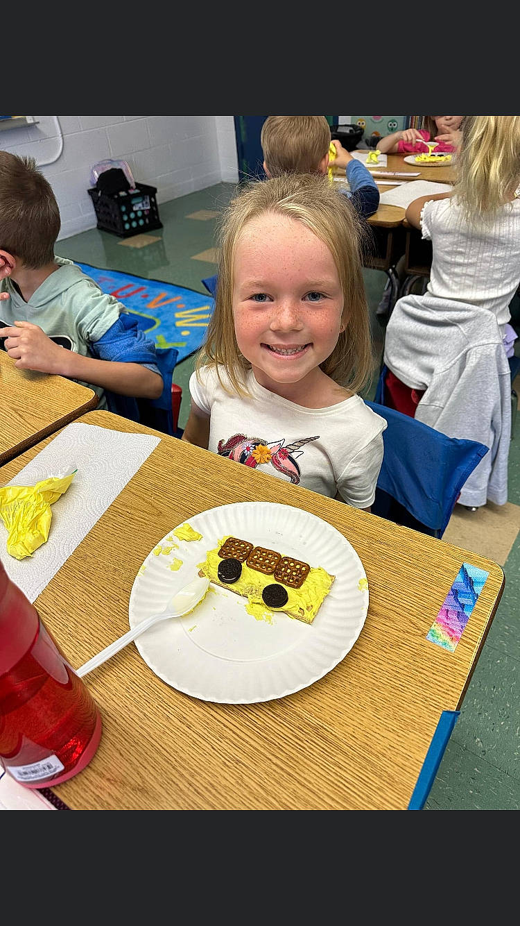 Bentlee is registered to the contest to win money with this photo: cake, chair, child, cuisine, desk, dessert, dish, event, food, fun, ingredient, joy, person, plate, recipe, sharing, smile, sweetness, t_shirt, table