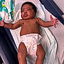 baby, infant, diaper, baby_wipes, medical_table, curly_hair, skin, arms, legs, expression, healthcare, clinic, cute, newborn, child, person, laying_down, indoors, mickey_mouse, waiting