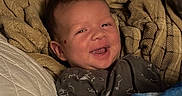 Michael joined the competition — help win amazing prizes! baby, blanket, child, clothing, comfort, cozy, cute, face, happy, head, indoor, infant, person, portrait, quilt, resting, smiling, soft, warm, young