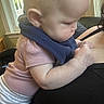 baby, infant, child, pink_shirt, striped_pants, blue_scarf, indoor, window, adult, black_clothing, skin, face_profile, leaning, cuddling, person, closeup, home, light, daylight, cute