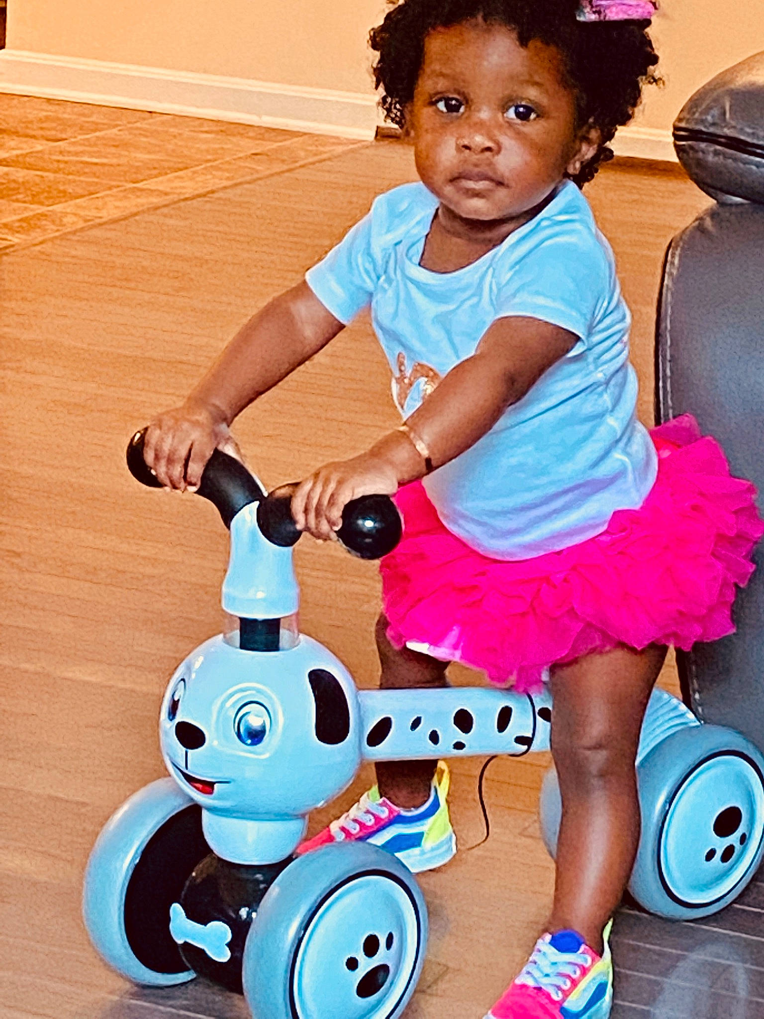Monroe is registered to the contest to win money with this photo: baby_toddler_clothing, blue, child, electric_blue, facial_expression, fun, happy, magenta, person, photograph, pink, product, riding_toy, rolling, smile, snapshot, tire, toddler, vehicle, wheel