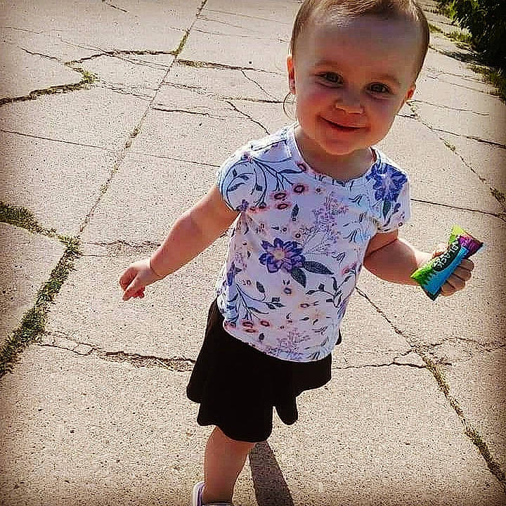 Delilah is registered to the contest to win money with this photo: baby, child, cool, design, dress, footwear, hand, happy, joy, leg, people, person, play, shadow, shoe, smile, standing, summer, t_shirt, toddler