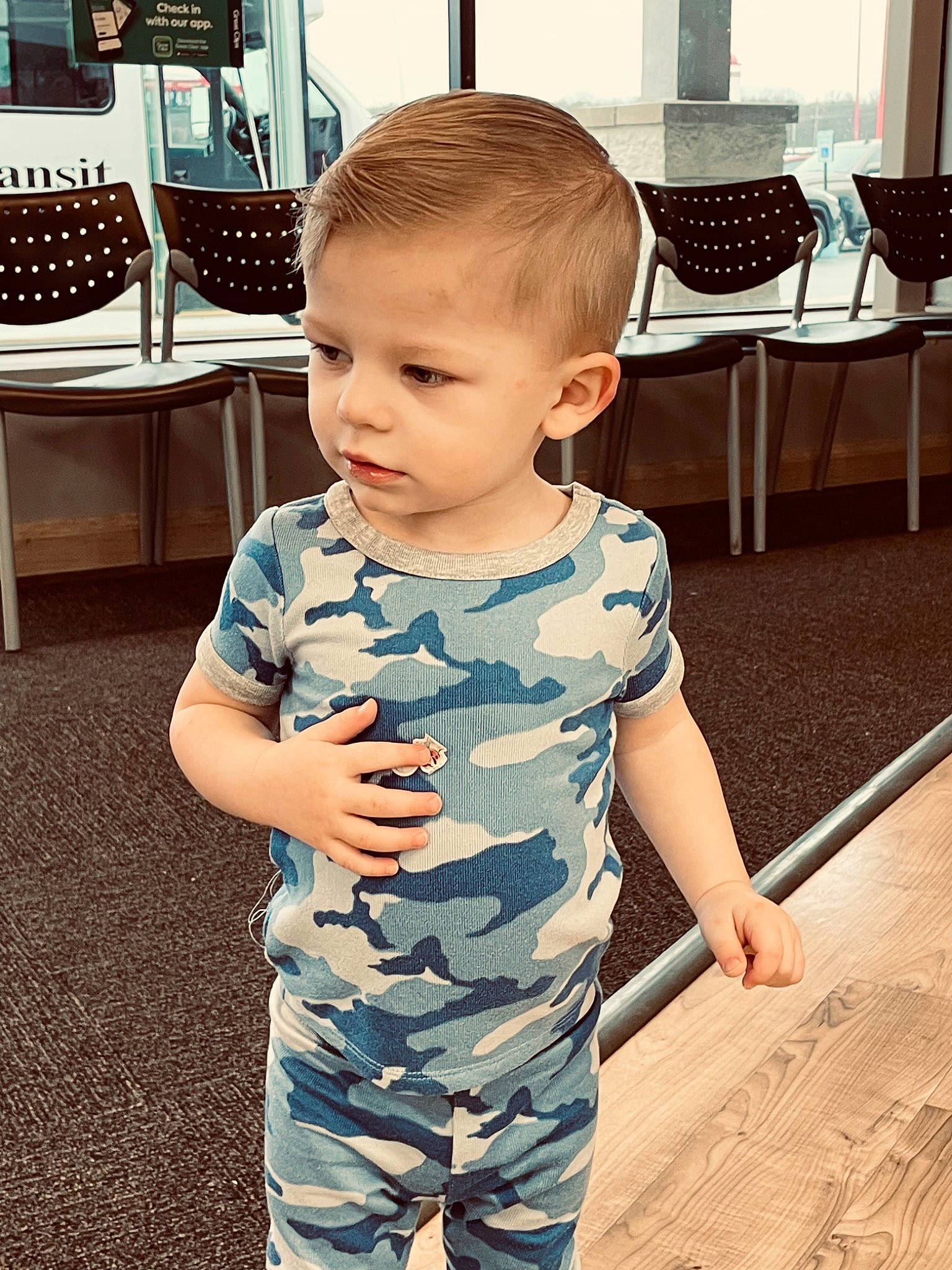 Nash is registered to the contest to win money with this photo: baby, baby_toddler_clothing, chair, child, cool, electric_blue, face, floor, flooring, fun, happy, neck, person, shoulder, skin, sleeve, standing, t_shirt, toddler, white