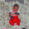 Kareem joined the competition — help win amazing prizes! baby, sleeping, infant, child, portrait, indoors, blanket, teddy_bears, red_clothing, white_clothing, onesie, mittens, socks, lying_down, peaceful, cute, face, closed_eyes, bed, heart_emojis