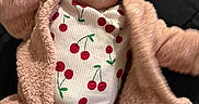 Nova Rios joined the competition — help win amazing prizes! baby, infant, child, cute, face, clothing, jacket, onesie, pattern, cherry, pink, fuzzy, warm, lying_down, person, indoor, portrait, soft_texture, young, adorable