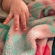 Nova Rios joined the competition — help win amazing prizes! baby_hand, infant, fingers, gesture, peace_sign, blanket, soft_texture, pastel_colors, pink, teal, close_up, skin, nails, cute, resting, cozy, warm, child, baby, toddler