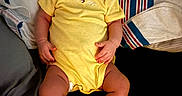 Nova Rios is registered to the contest to win money with this photo: baby, bed, blanket, child, clothing, comfortable, cute, indoors, infant, lying_down, peaceful, person, pillow, resting, sleeping, socks, soft_lighting, toddler, yellow_onesie, young_child
