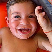 Kellyam participe au concours pour gagner de l'argent avec cette photo : toddler, child, smiling, wet, water, inflatable, pool, orange, skin, face, happy, closeup, summer, play, outdoor, fun, cute, baby, hand, floating