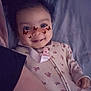 Naomi is registered to the contest to win money with this photo: baby, child, smile, face, butterfly_filter, onesie, floral_pattern, lying_down, bedtime, blanket, infant, cute, indoors, soft_lighting, happy, portrait, young_child, sleepwear, human, closeup