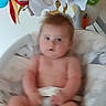 baby, baby_seat, blur, child, childhood, colorful_toy, cushion, cute, diaper, face, furniture, head, indoor, infant, mobile, person, plush_toy, seat, skin, toy