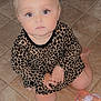 baby, child, toddler, sitting, floor, tile, leopard_print, dress, hair_bow, pink, face, eyes, hands, legs, sippy_cup, indoor, curious, expression, person, clothing