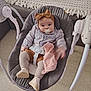 baby, infant, pacifier, headband, plush_toy, baby_rocker, shirt, shorts, tights, shoes, blanket, couch, floor, indoor, child, person, cute, comfortable, seated, toy
