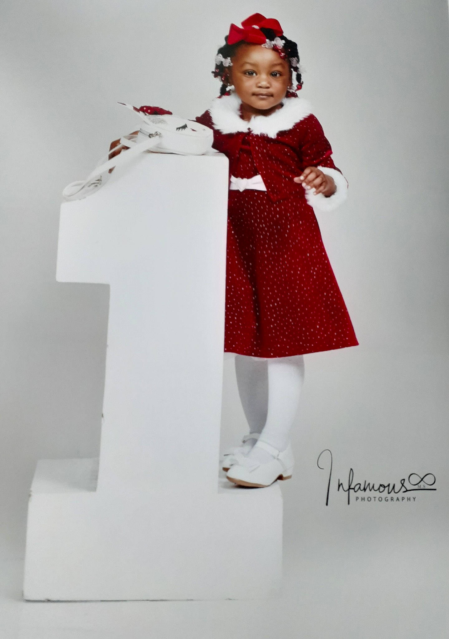 Lovely is registered to the contest to win money with this photo: carmine, child_model, christmas, costume, costume_accessory, costume_hat, day_dress, dress, embellishment, fashion_design, fictional_character, hair_accessory, headband, headpiece, headwear, one_piece_garment, person, red, sleeve, standing