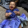 Khloe Grace is registered to the contest to win money with this photo: baby, child, smiling, laughing, blue_dress, carpet, hands, clothing, blanket, fabric, happy, person, indoor, cute, toddler, playful, portrait, closeup, infant, joyful