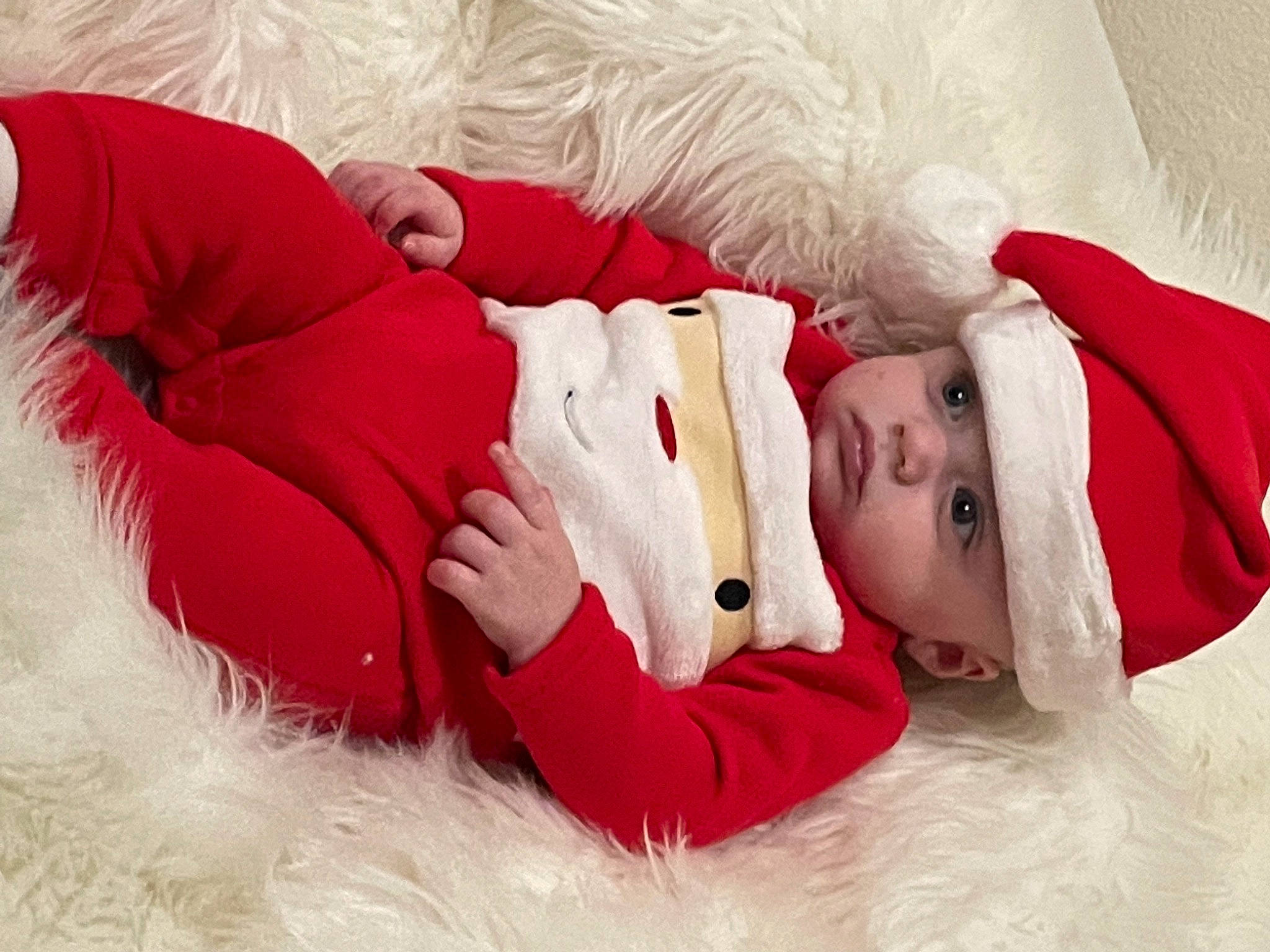Axtyn is registered to the contest to win money with this photo: baby, baby_toddler_clothing, carmine, child, christmas, christmas_eve, comfort, event, fur, happy, hat, headwear, holiday, human_leg, linens, mammal, person, santa_claus, skin, textile