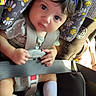 Symphoney is registered to the contest to win money with this photo: accessories, baby, belt, car, car_interior, carseat, clothing, cushion, face, footwear, hat, head, homedecor, person, photography, portrait, shoe, sneaker, transportation, vehicle