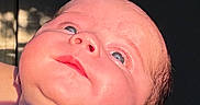 Oliver is registered to the contest to win money with this photo: baby, infant, child, portrait, face, eyes, looking_up, close_up, smiling, light_skin, hair, striped_clothing, blue_shirt, being_held, indoor, dramatic_lighting, photography, person, head, safe