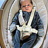 baby, infant, child, portrait, lying_down, rocker, baby_seat, harness, cushion, striped_clothing, mittens, wide_eyes, indoor, tiled_floor, wood, furniture, cozy, adorable, photography, safe