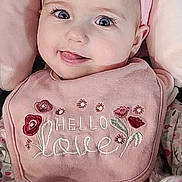 Whitney joined the competition — help win amazing prizes! baby, bib, big_eyes, car_seat, cheeks, closeup, clothing, cozy, cute, eyelashes, fabric, floral, headband, infant, pink_bow, pink_color, portrait, seatbelt, smiling, tongue_out