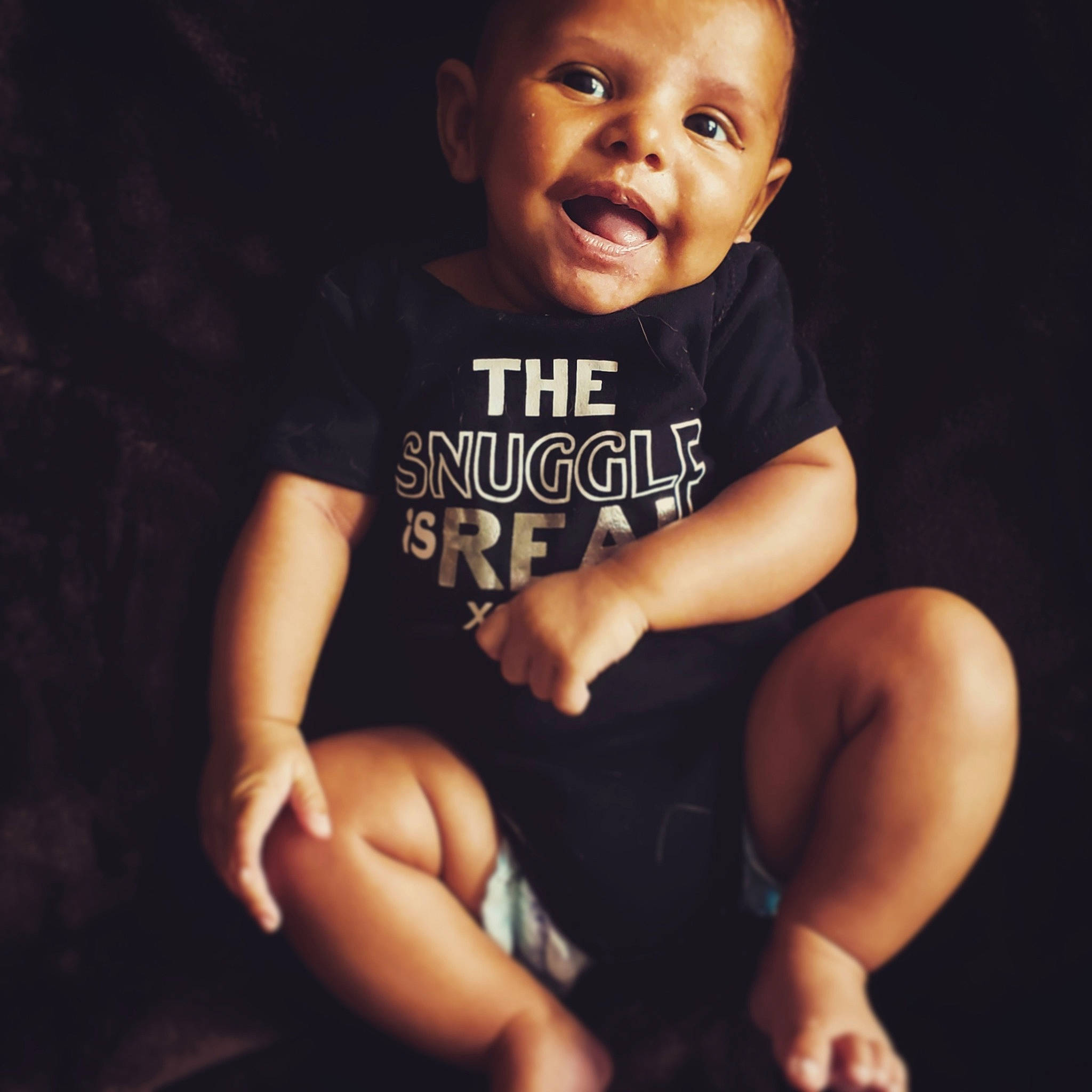 Juelz is registered to the contest to win money with this photo: arm, baby, black, cheek, child, cool, face, finger, hand, head, human, leg, male, muscle, person, photography, sitting, skin, smile, t_shirt