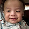Luca is registered to the contest to win money with this photo: baby, smiling, face, child, indoor, onesie, dinosaur, clothing, portrait, cute, happy, infant, person, head, young, toddler, closeup, expression, skin, cheeks