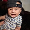 Luca joined the competition — help win amazing prizes! baby, child, smiling, cap, hat, striped_clothing, onesie, portrait, indoors, person, cute, happy, face, young_child, infant, headwear, casual, closeup, holding, babywearing