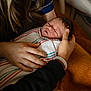 Dawson is registered to the contest to win money with this photo: newborn, baby, sleeping, swaddled, blanket, hospital, hands, adult, tender, care, closeup, portrait, resting, gentle, indoor, person, human, skin, comfort, love