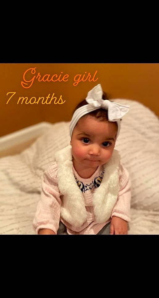 Gracie is registered to the contest to win money with this photo: baby, baby_toddler_clothing, child, comfort, flash_photography, font, fun, fur, gesture, happy, human_body, laugh, love, peach, person, photo_caption, portrait_photography, sitting, sleeve, smile