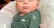 Axl joined the competition — help win amazing prizes! baby, blanket, brown_leather_chair, child, cozy, cute, face, green_clothing, hands_in_pockets, indoor, infant, nap, onesie, peaceful, portrait, relaxing, sleeping, soft_texture, toddler, white_blanket