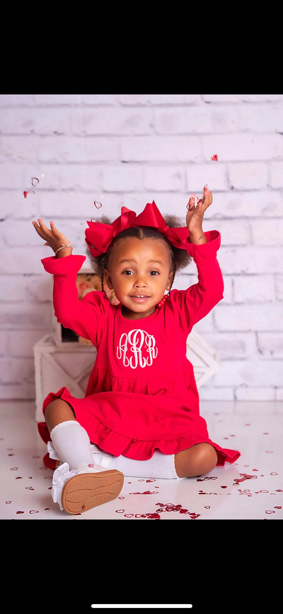 Addisyn is registered to the contest to win money with this photo: baby, baby_toddler_clothing, cheek, child, chin, dress, eye, face, fashion_accessory, happy, head, magenta, person, pink, red, sitting, skin, sleeve, smile, t_shirt