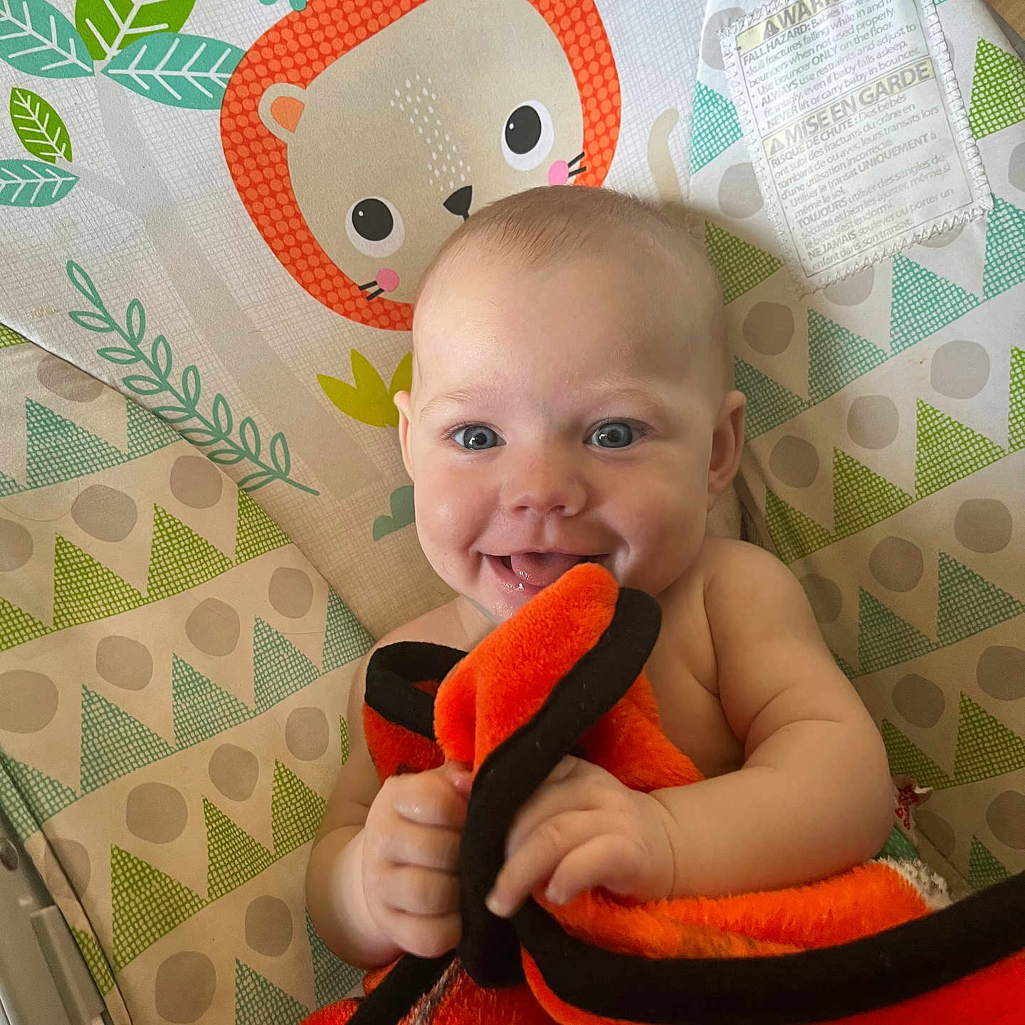 Serenity is registered to the contest to win money with this photo: animal_illustration, baby, baby_chair, blanket, blue_eyes, cheerful, child, colorful, cute, face, hand, happy, indoor, infant, lion, pattern, portrait, skin, smiling, toy