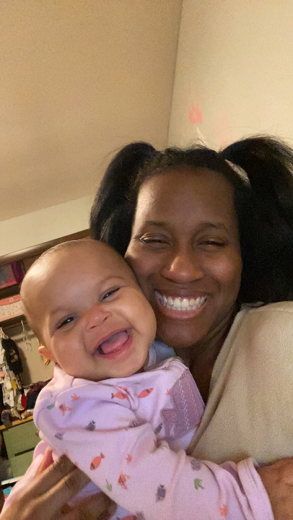 Amiyah is registered to the contest to win money with this photo: baby, baby_toddler_clothing, bookcase, cheek, chin, comfort, eyebrow, facial_expression, fun, gesture, hairstyle, happy, interaction, iris, joy, lip, mouth, nose, person, shelf