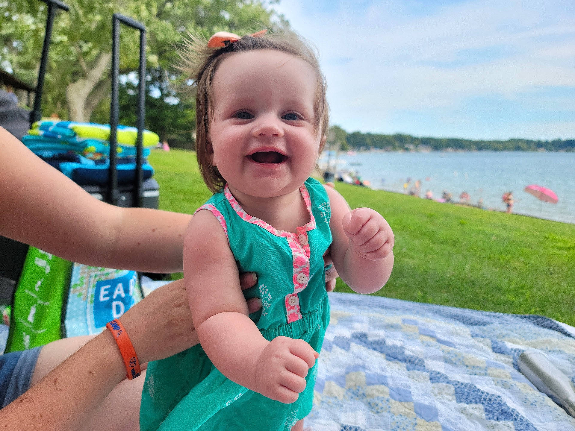 Aubrey is registered to the contest to win money with this photo: baby, baby_toddler_clothing, cloud, face, finger, fun, gesture, grass, happy, lake, leisure, person, plant, recreation, skin, sky, smile, summer, toddler, tree