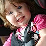 toddler, child, car_seat, seatbelt, pink_shirt, blue_eyes, smiling, sitting, indoors, safety, cute, young_child, person, portrait, happy, hair, clothing, baby, car_interior, child_seat