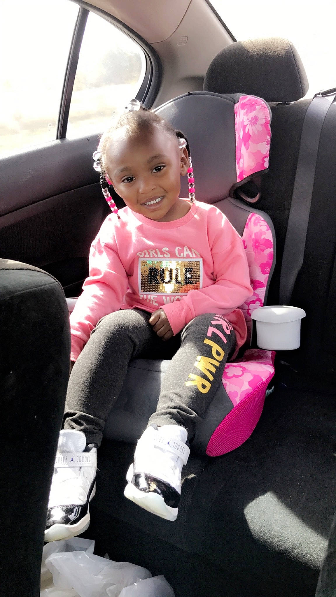 Kadence is registered to the contest to win money with this photo: auto_part, baby_in_car_seat, car, car_seat, car_seat_cover, child, family_car, joy, person, pink, seat_belt, toddler, vehicle
