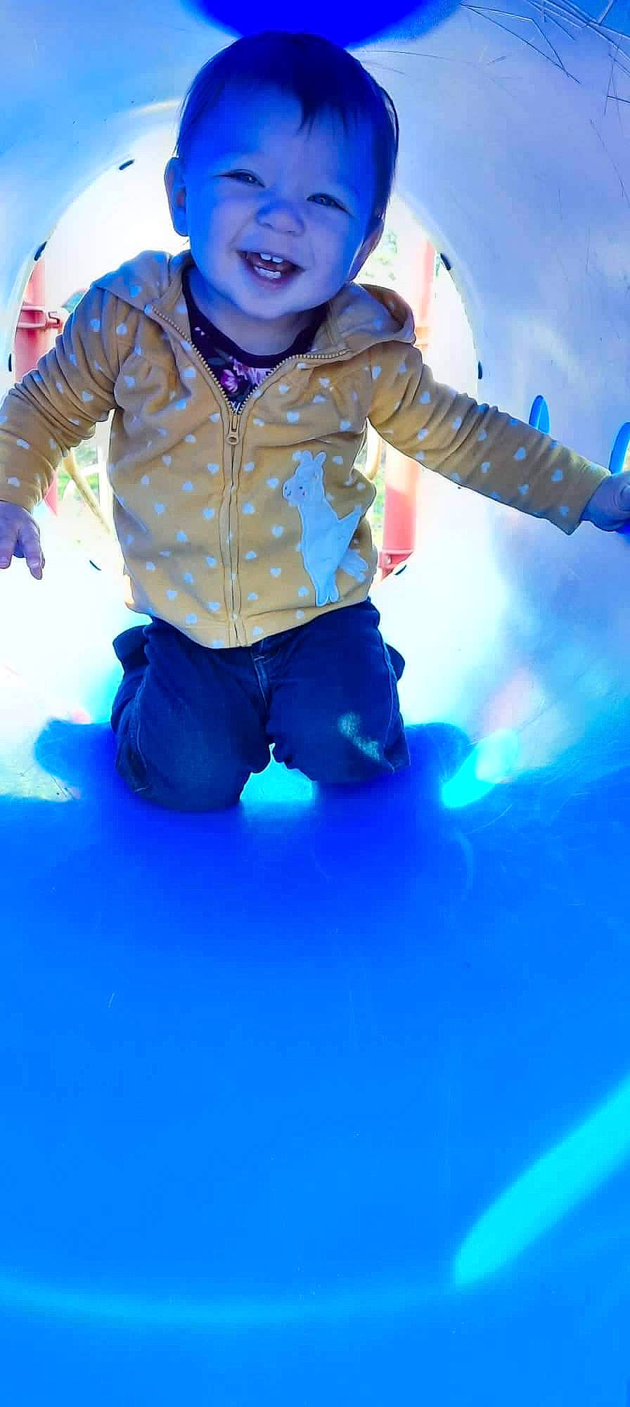 Amanda is registered to the contest to win money with this photo: baby_toddler_clothing, blue, child, electric_blue, fun, gesture, glove, happy, jacket, leisure, magenta, person, personal_protective_equipment, play, recreation, sleeve, smile, sunglasses, toddler, toy