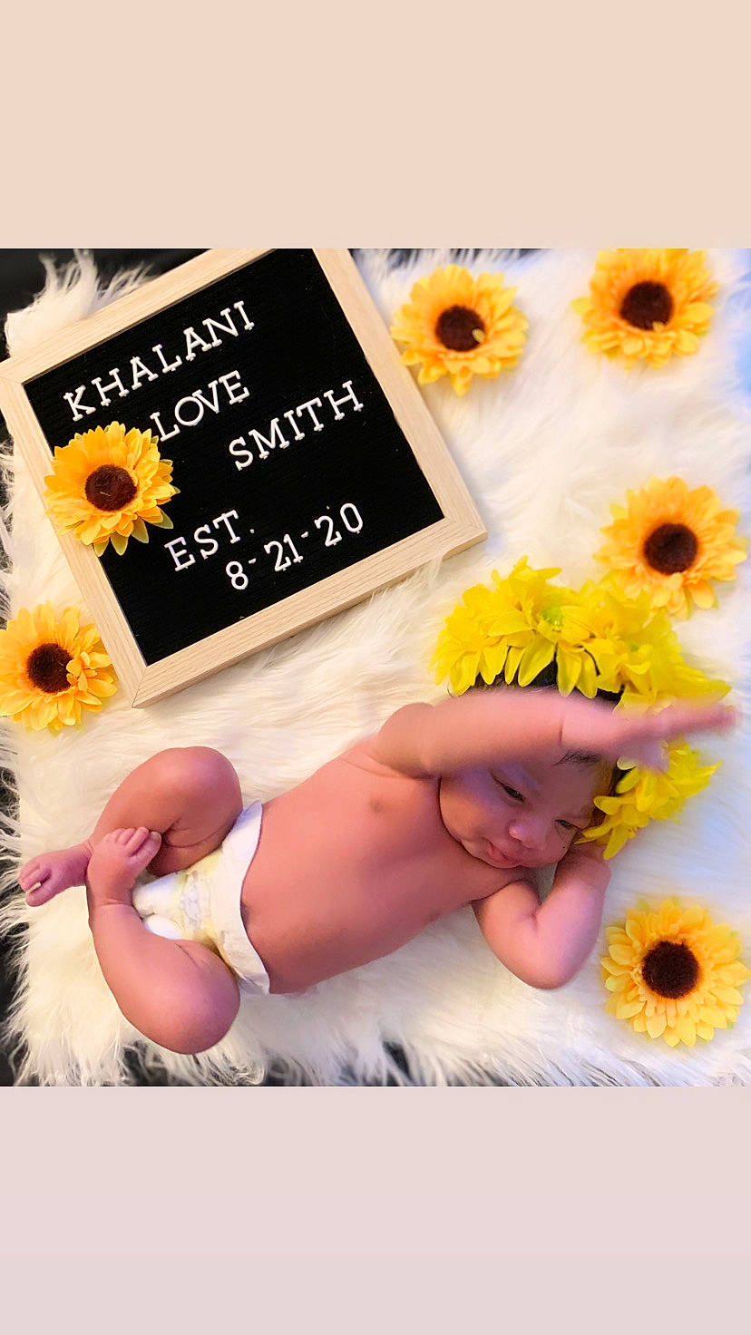 Khalani is registered to the contest to win money with this photo: child, flower, font, gerbera, person, photo_caption, photography, plant, smile, sunflower, toddler, yellow