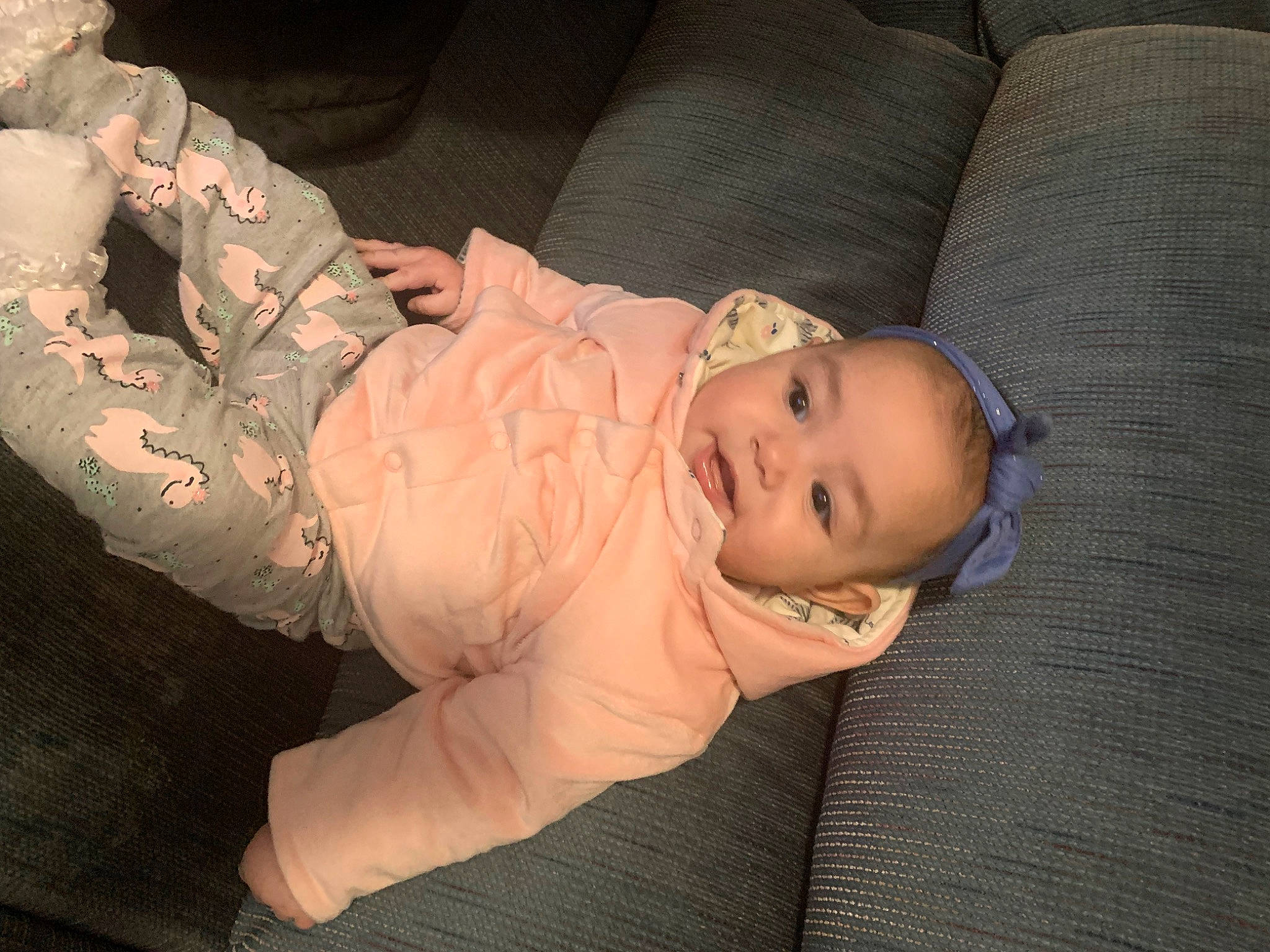 Natalie is registered to the contest to win money with this photo: abdomen, baby, baby_toddler_clothing, camouflage, cheek, chest, child, comfort, elbow, finger, gesture, military_camouflage, person, personal_protective_equipment, sitting, skin, sleeve, smile, toddler, tree