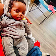 King Truth joined the competition — help win amazing prizes! baby, sleeping, child, person, hoodie, tracksuit, gray_clothing, socks, indoor, floor, blanket, hand, furniture, home, relaxation, comfort, cute, peaceful, infant, portrait