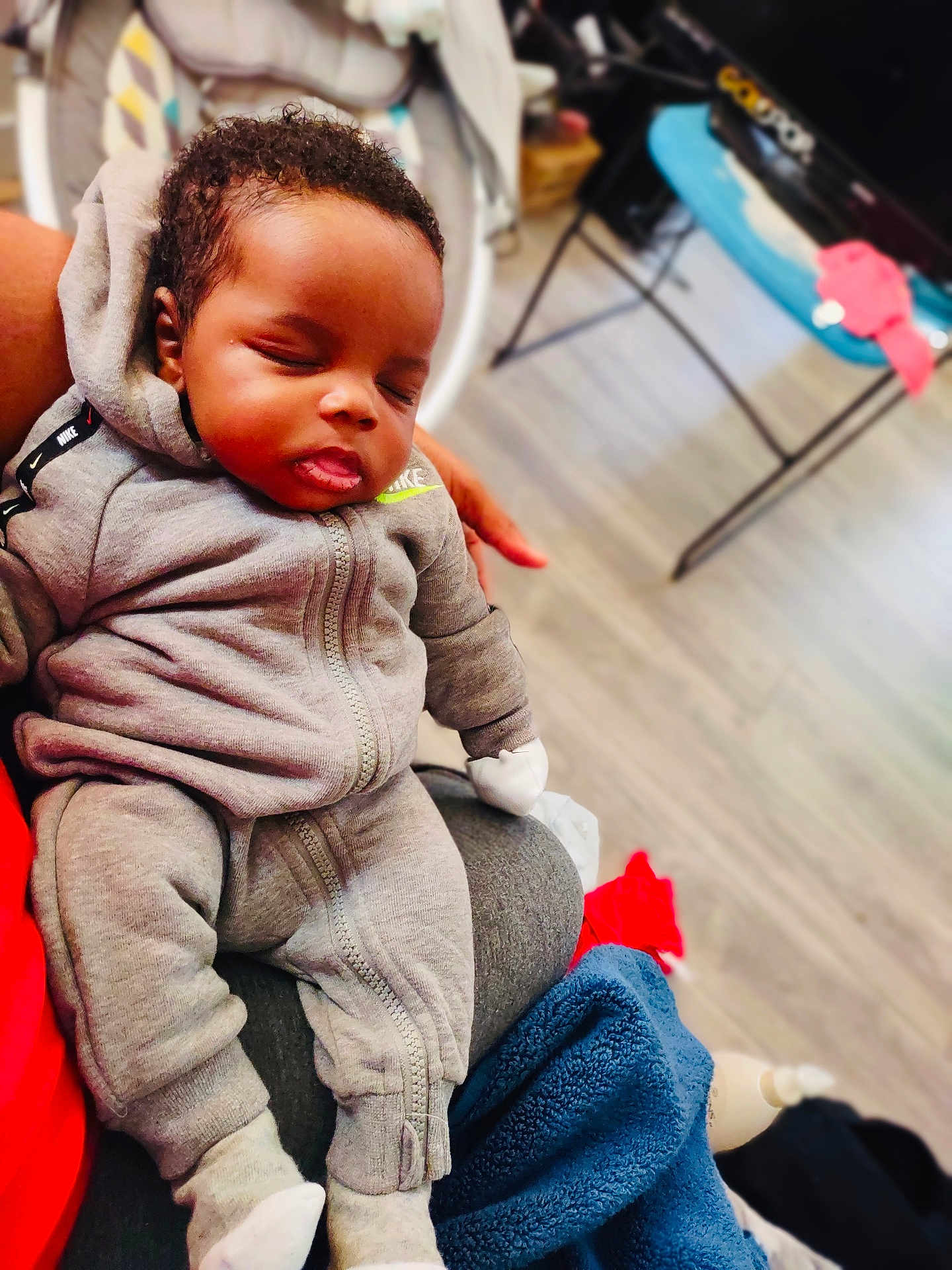 King Truth joined the competition — help win amazing prizes! baby, sleeping, child, person, hoodie, tracksuit, gray_clothing, socks, indoor, floor, blanket, hand, furniture, home, relaxation, comfort, cute, peaceful, infant, portrait