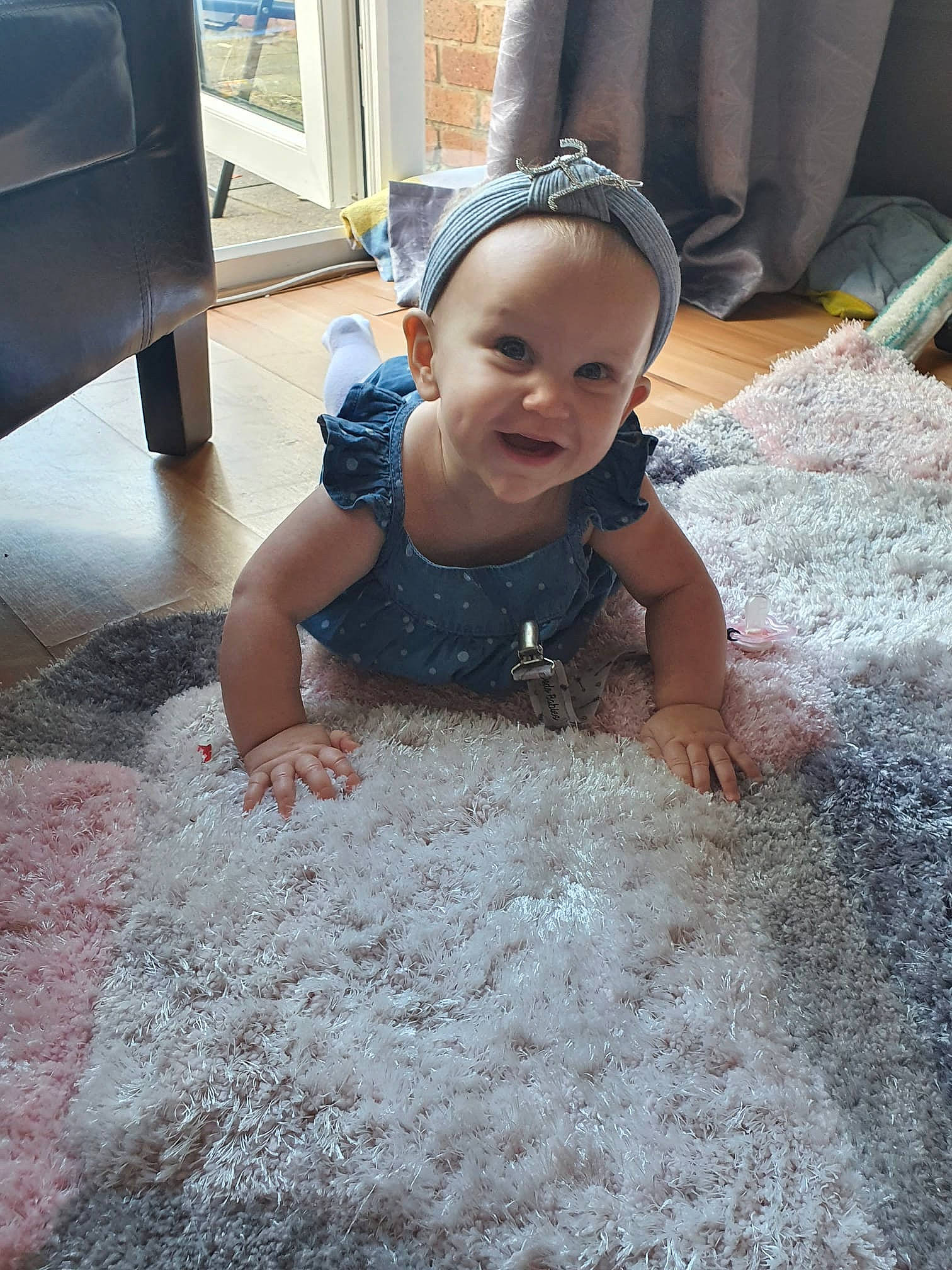April is registered to the contest to win money with this photo: baby, baby_toddler_clothing, carpet, child, concrete, crawling, event, fashion_accessory, floor, flooring, fun, happy, headband, headpiece, jewellery, person, sand, smile, soil, toddler