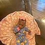 Rosa joined the competition — help win amazing prizes! baby, child, onesie, pink_bow, blanket, floral_pattern, brown_chair, indoor, wooden_floor, furniture, thumb_sucking, cute, infant, seated, cozy, face, person, small_child, clothing, portrait
