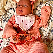 Lakelyn joined the competition — help win amazing prizes! baby, infant, pink_clothing, headband, blanket, floral_pattern, lying_down, cute, newborn, soft_texture, cozy, face, expression, child, indoors, comfort, sleepwear, small_hands, adorable, resting