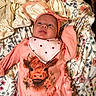 Lakelyn joined the competition — help win amazing prizes! baby, infant, child, headband, bow, outfit, highland_cow, floral_blanket, lying_down, cute, smiling, clothing, pink, pattern, face, skin, expression, indoors, soft_texture, newborn