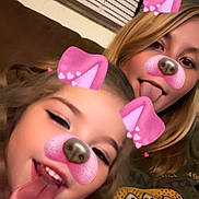 Aylani joined the competition — help win amazing prizes! blinds, casual, child, couch, dog_filter, face, filter, fun, happy, indoor, long_hair, pink_ears, pink_nose, playful, red_clothing, selfie, smiling, tongue_out, two_people, woman