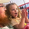 child, toddler, man, beard, glasses, cap, clapping, happy, indoor, event, crowd, bench, curly_hair, pink_blanket, excited, person, portrait, side_view, casual_clothing, family