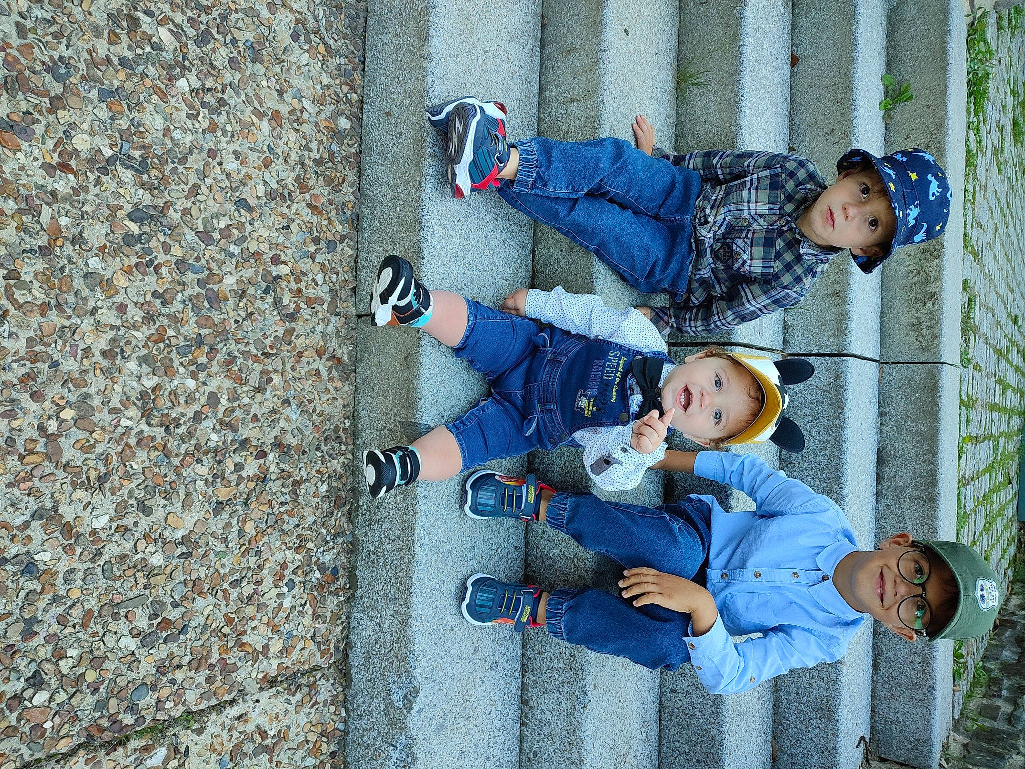Patrick participe au concours pour gagner de l'argent avec cette photo : asphalt, child, cobblestone, concrete, denim, electric_blue, fun, headwear, jeans, joy, leisure, pattern, person, road_surface, sitting, smile, sneakers, toddler, travel, walking_shoe